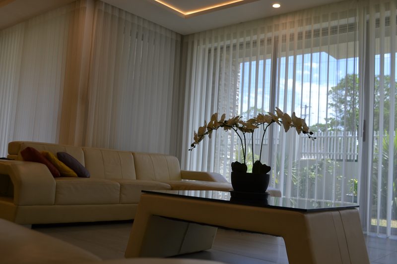 Sheer S-fold curtains framing a sunlit Perth living room