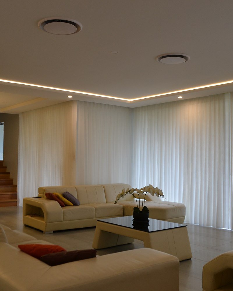 Floor-to-ceiling sheer curtains in a calm, light-filled room